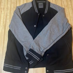 This is a black and gray letterman jacket made of cotton and polyester.